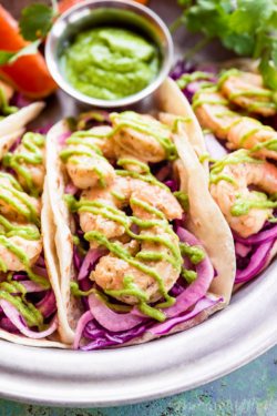 No boring tacos here! These Orange Shrimp Tacos from https://meatified.com are spiced with ginger, piled high with a crunchy, punchy slaw, finished with a rich avocado cream & held together with a grain free tortilla.