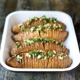 Hasselback Sweet Potatoes with Compound Herb Ghee from The Performance Paleo Cookbook