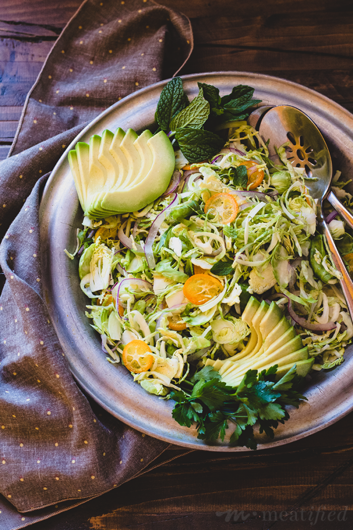 Shaved Brussels Salad with Avocado, Kumquats & Anchovy Dressing from http://meatified.com | This shaved brussels salad is like slaw, only better! It's crunchy, vibrant & a great way to get some extra greens, tossed with a punchy, zingy dressing.