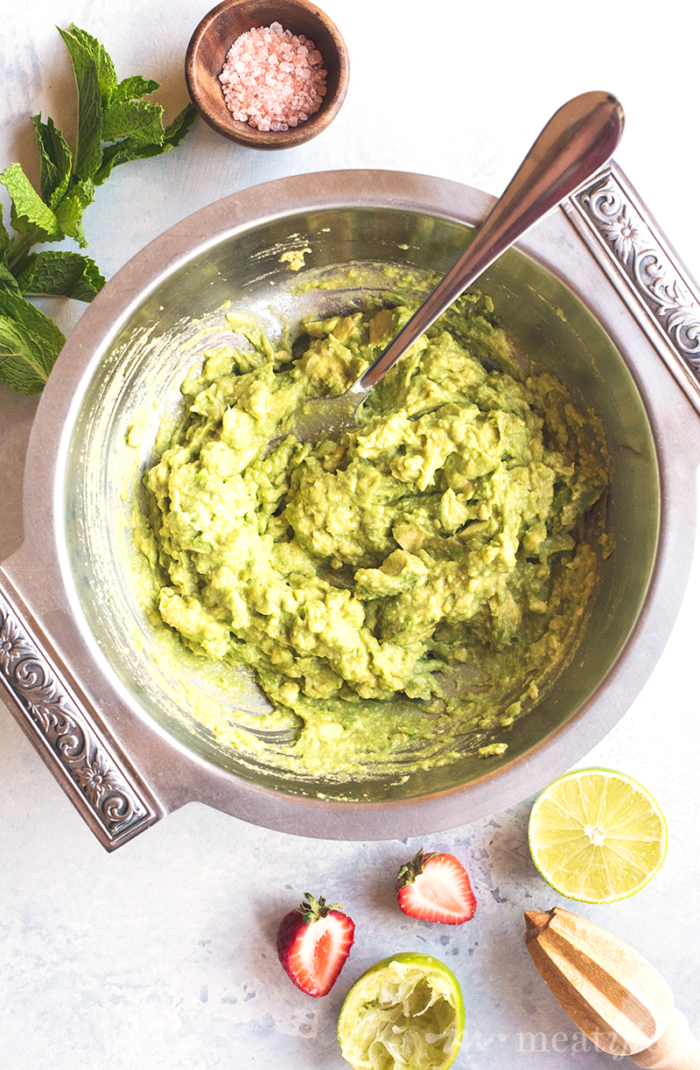 Switch up your guac game with this summery Strawberry Guacamole from http://meatified.com. Flecked with strawberries, green onion & mint for a fun twist on the classic favorite.