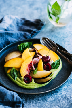 Everything fresh & summery is wrapped up in this stone fruit salad! Fresh peaches, plums & cherries shine against a vibrant green basil avocado sauce from https://meatified.com.