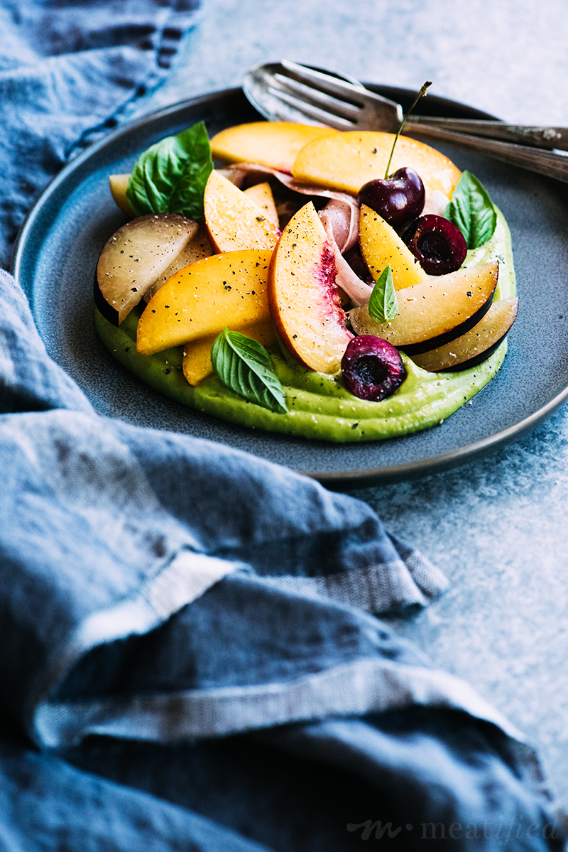 Everything fresh & summery is wrapped up in this stone fruit salad! Fresh peaches, plums & cherries shine against a vibrant green basil avocado sauce from https://meatified.com.