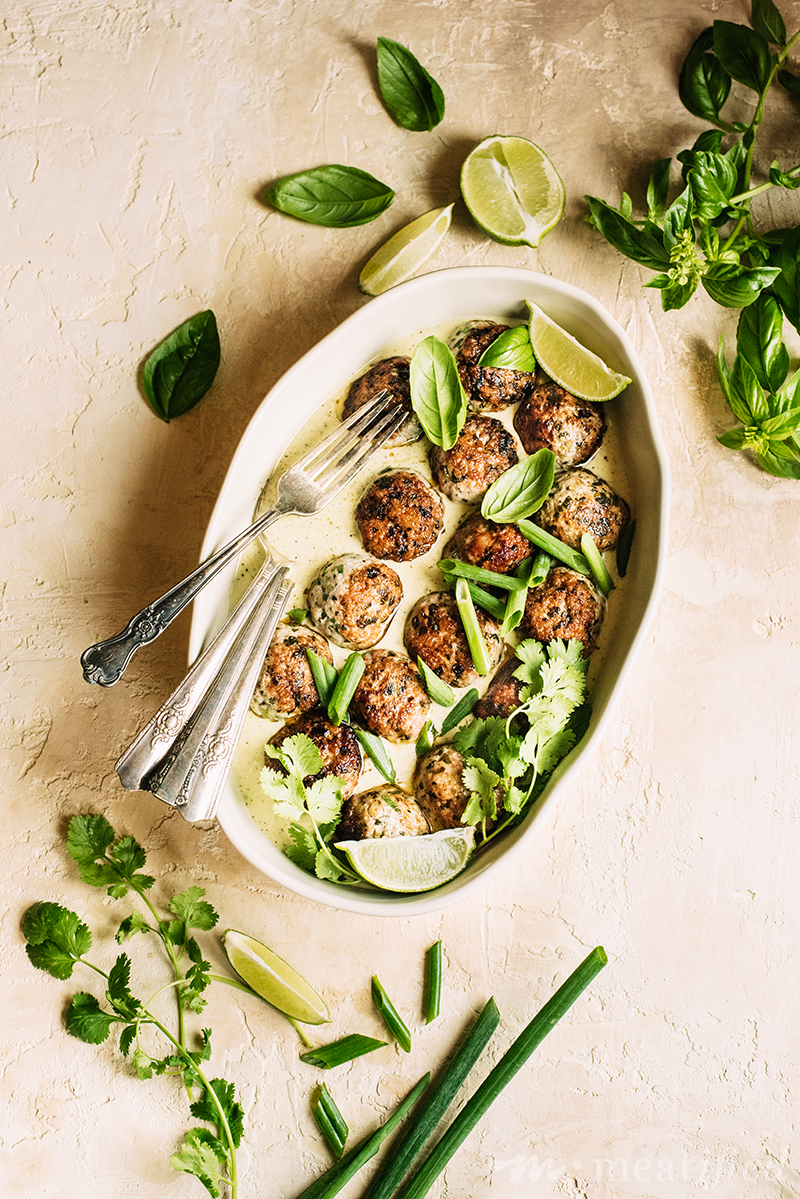 Herb studded meatballs take a dip in a nightshade free, aromatic Thai green curry sauce from https://meatified.com that will have you licking the bowl when you're done!