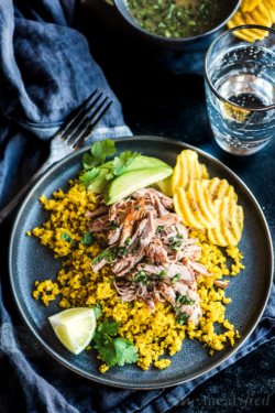 These Cuban pork bowls have tender pork piled on herbed cauli rice, drizzled with citrusy mojo sauce, finished with creamy avocado & crispy plantain chips.