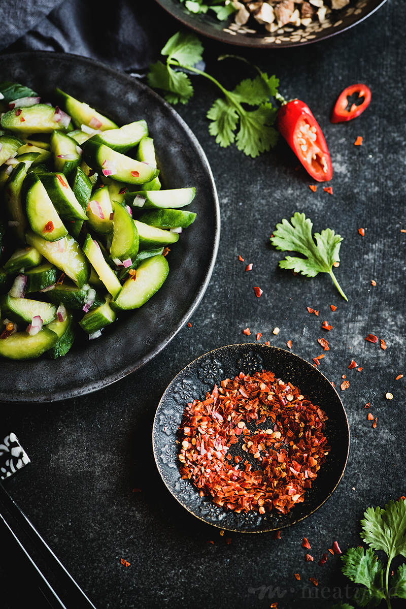This spicy cucumber salad is a refreshing side for almost every summer meal: crisp vegetables meet spicy sour dressing & a contrasting toasty topping.