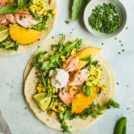These salmon tacos are the best of summer produce in one bite: juicy peach, creamy avocado, charred corn & fresh basil make simply prepared salmon shine!