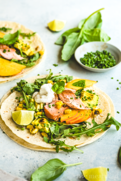 These salmon tacos are the best of summer produce in one bite: juicy peach, creamy avocado, charred corn & fresh basil make simply prepared salmon shine!