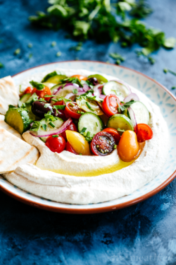 This silky smooth hummus leaves out the legumes but brings all the flavor, brightened with crunchy, fresh Mediterranean salad for the perfect summery meal.